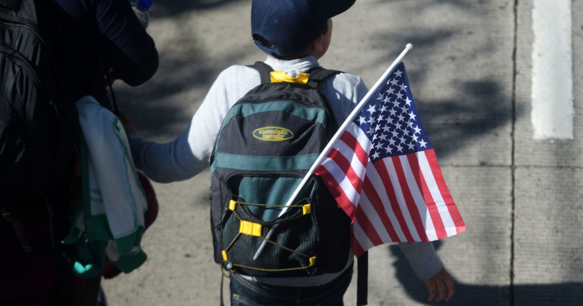 Fact Check: The Migrant Flag Burning Meme? Fake News.